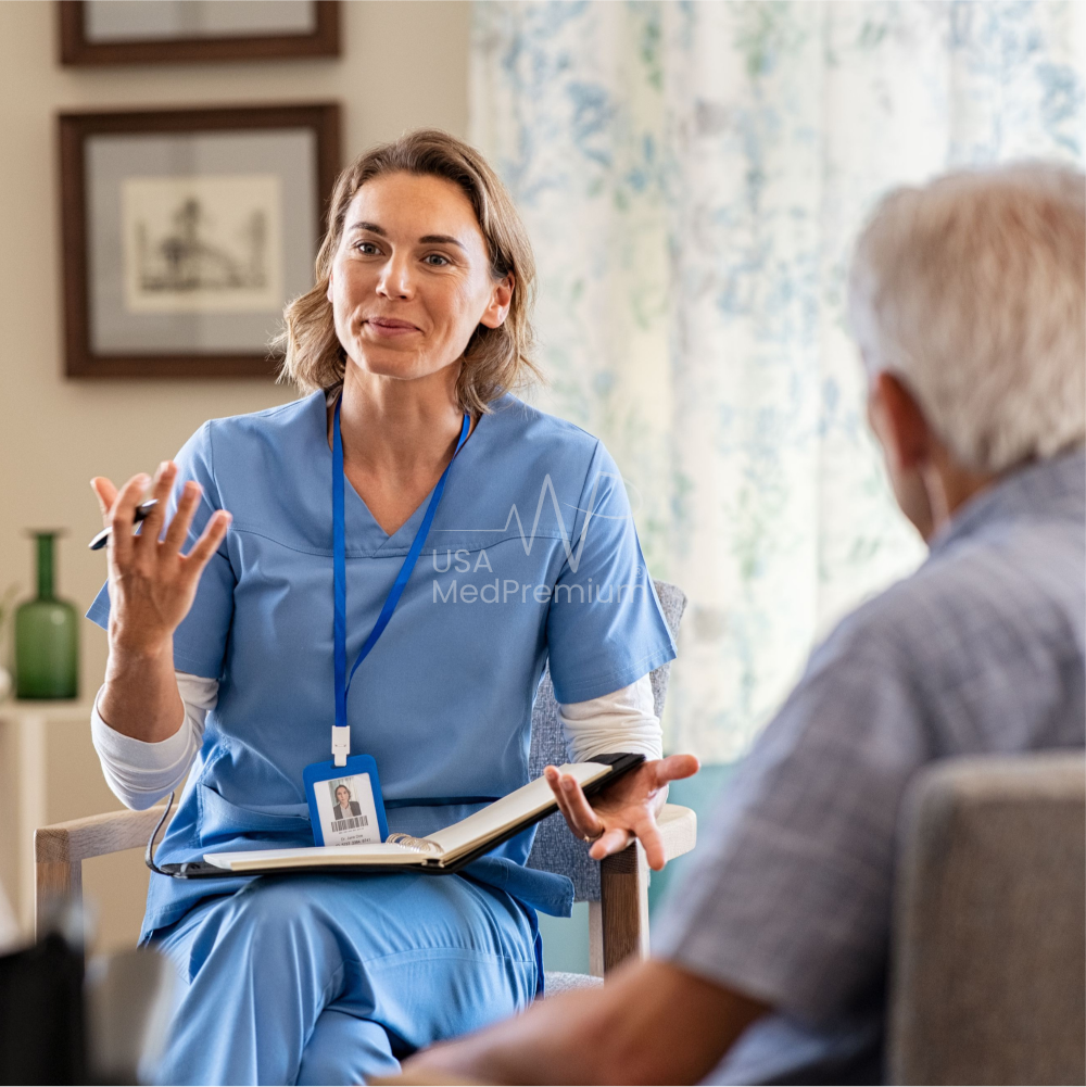 Nurse with a tablet sharing a laugh with a senior resident holding a teacup in her long-term care room