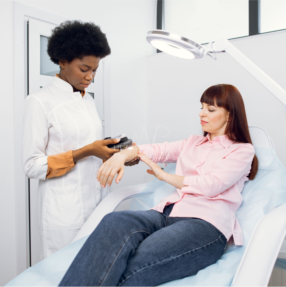 Nurse adjusting an infusion pump for a patient during oncology treatment